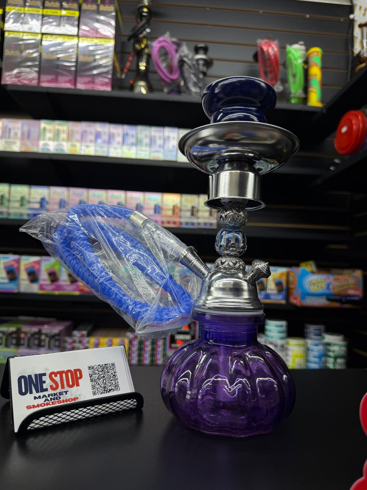 Purple glass hookah kit with hose on the counter at One Stop Market N Smoke Shop in Hialeah, FL.